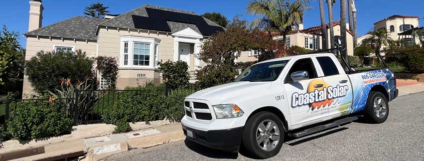 Coastal Solar service truck parked in front of home with solar panels installed.